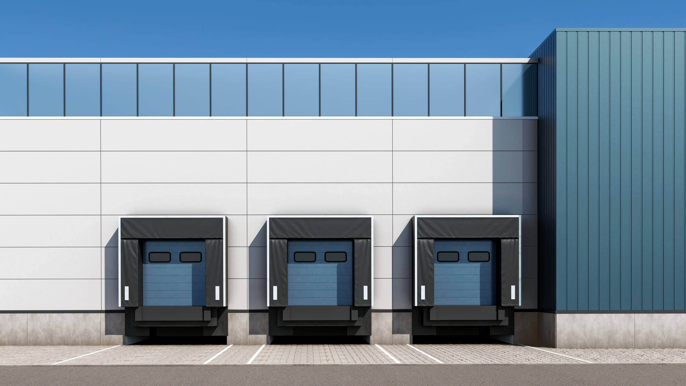 Loading docks of a logistics facility under a clear sky